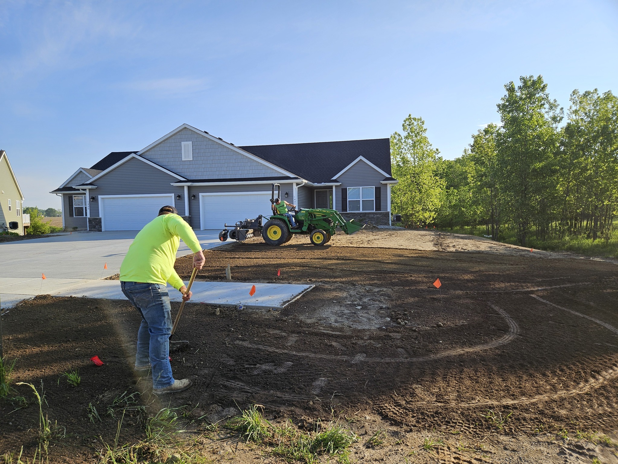 Construction worker preparing residential lawn.