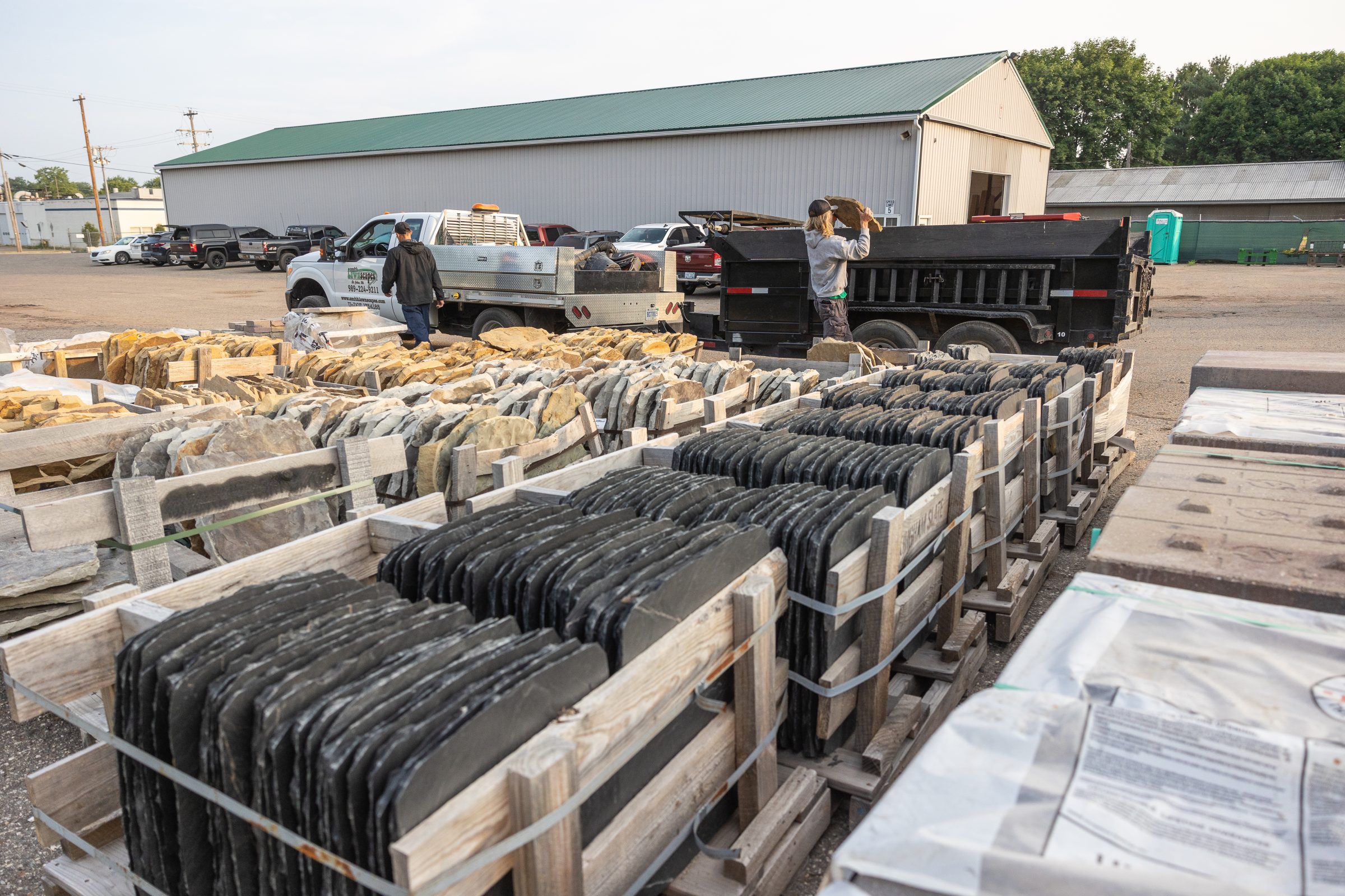 Crates of stone slabs in a yard.
