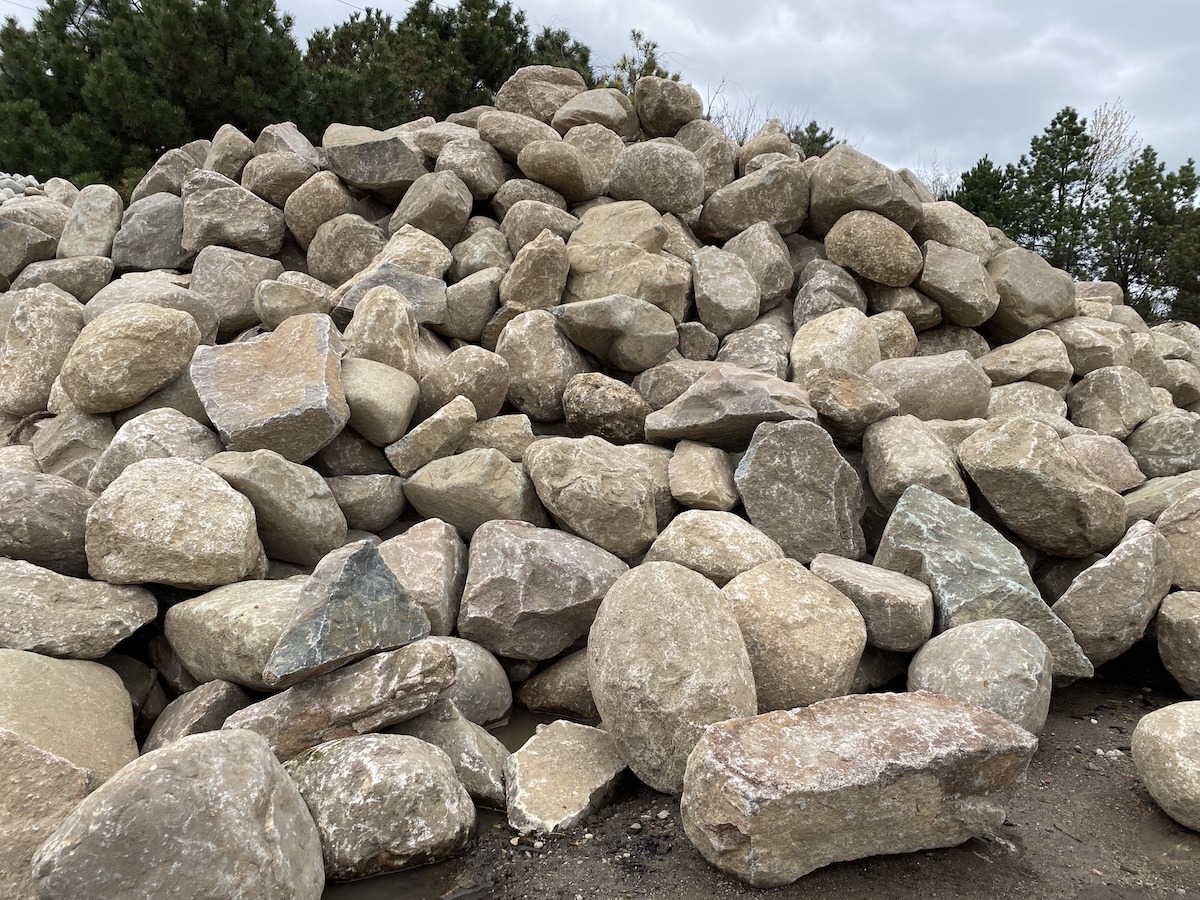 Pile of large rocks on ground.