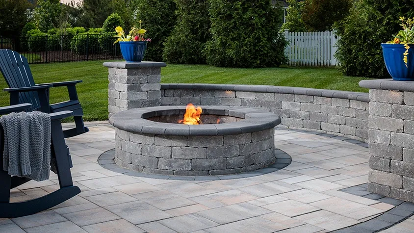 Backyard patio with circular stone fire pit