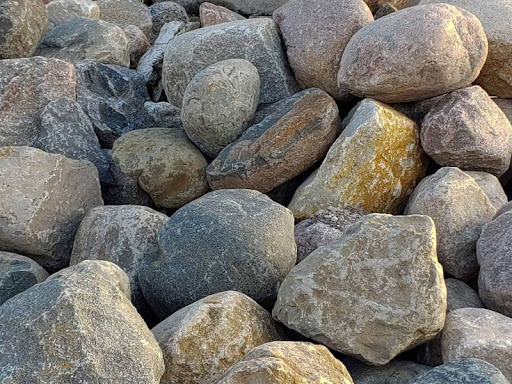 Pile of large, smooth gray and brown rocks.