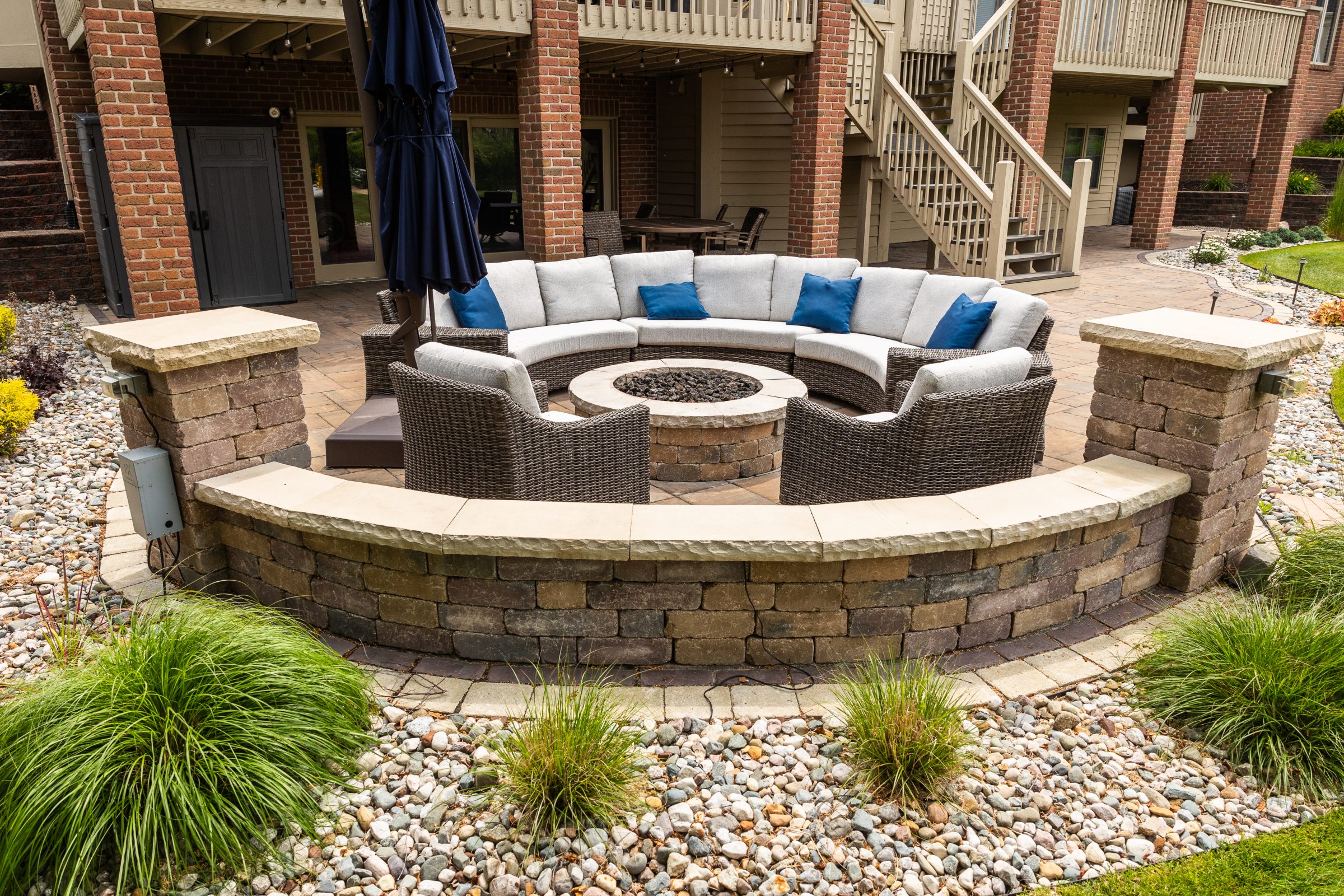 Outdoor patio with circular seating and fire pit.