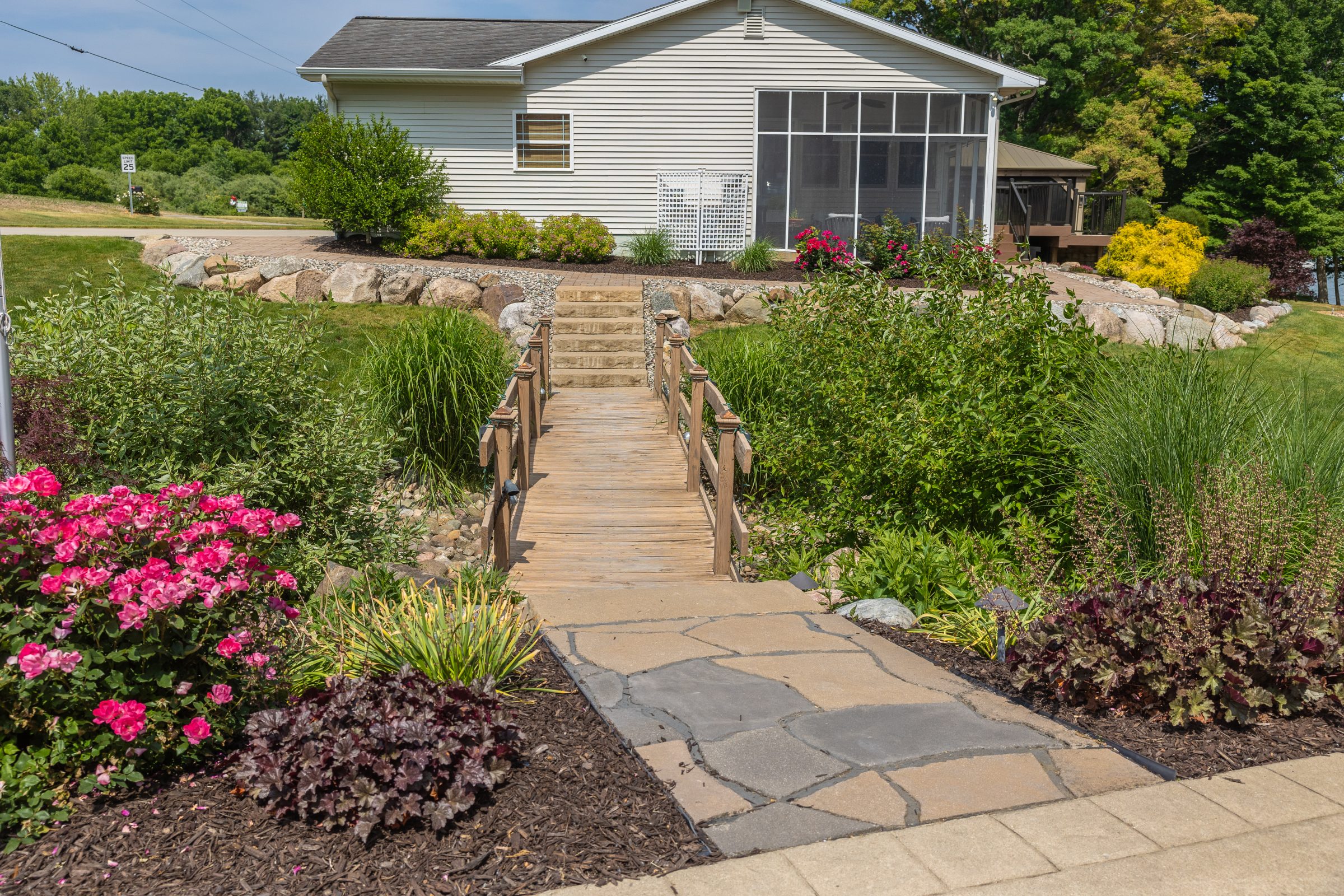 Garden path leading to white house veranda.