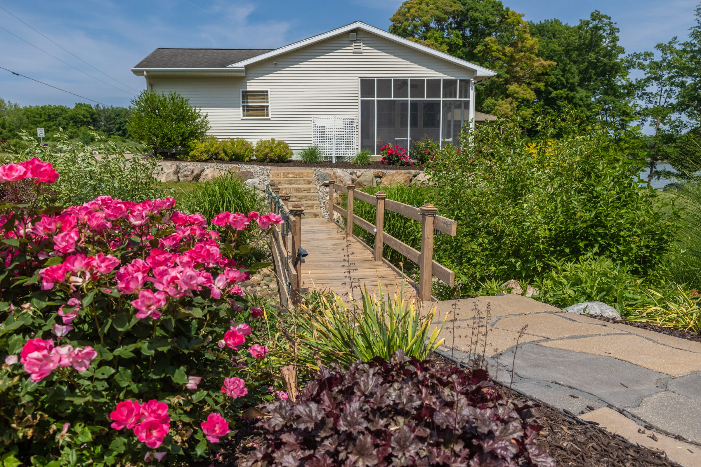 Cottage with garden bridge and colorful flowers