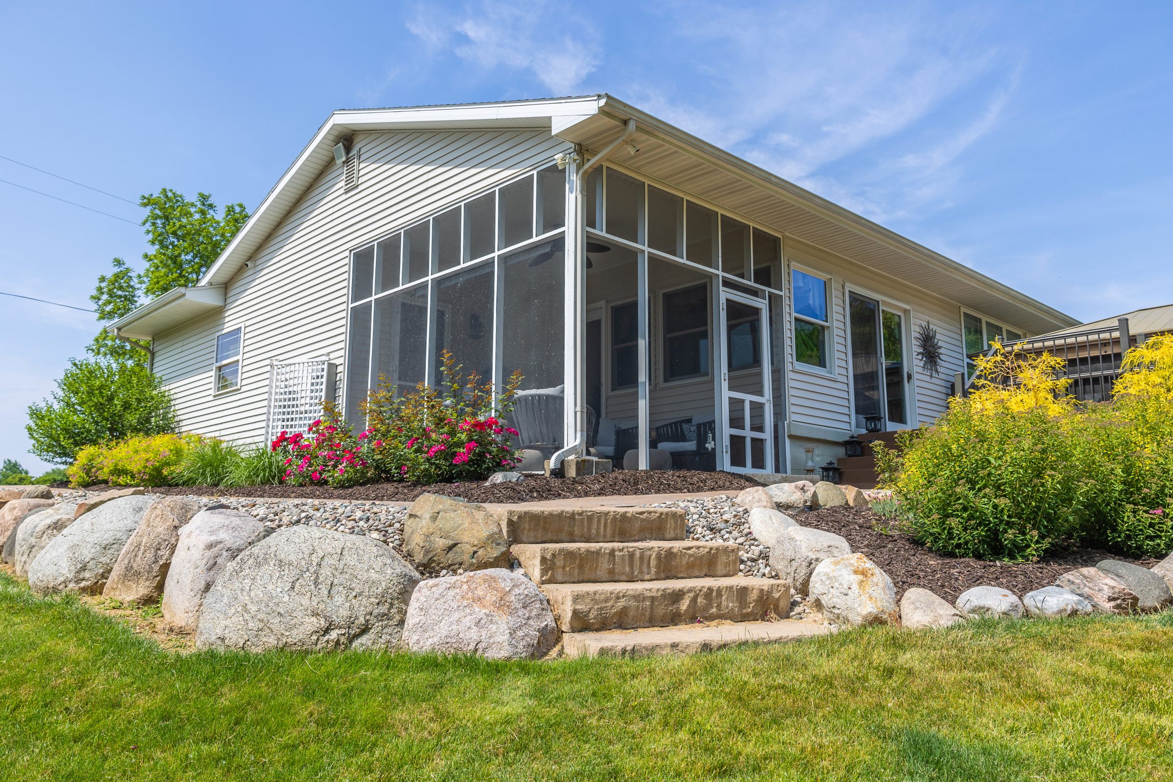 Charming house with flowers and stone pathway