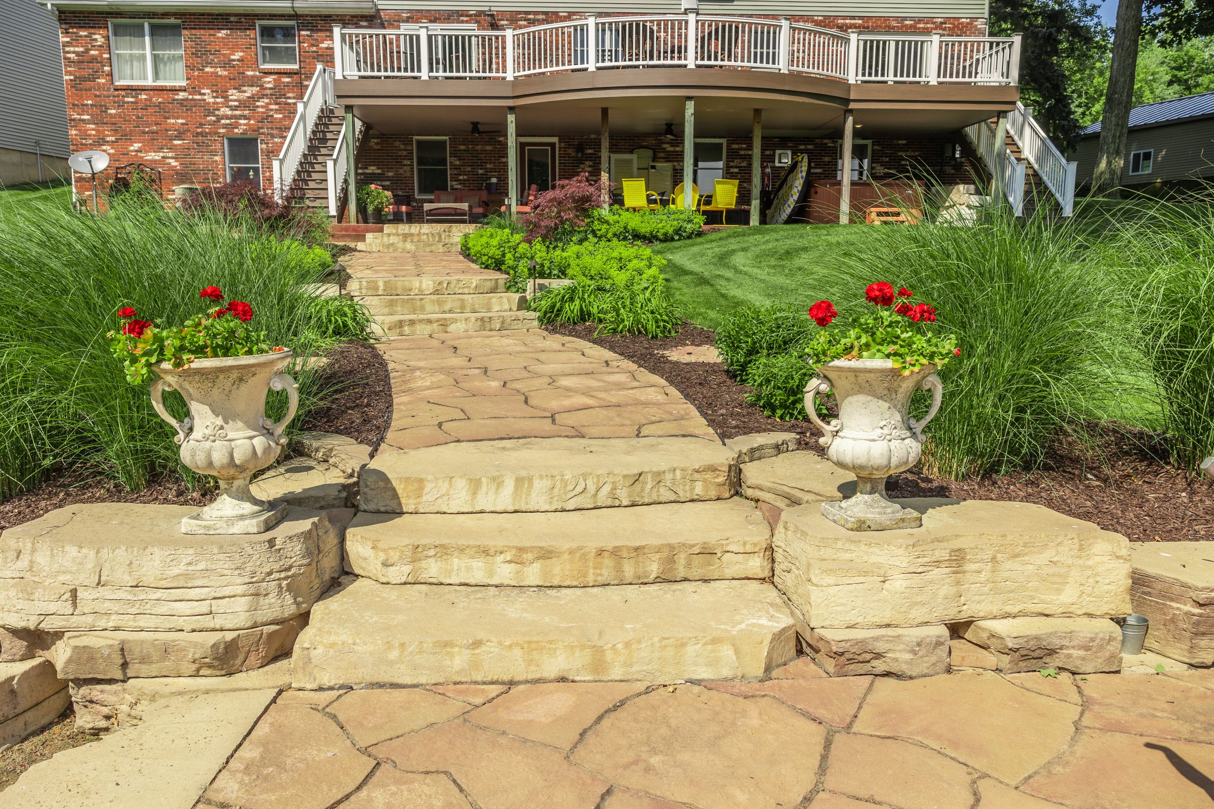 Stone pathway leading to a brick house backyard