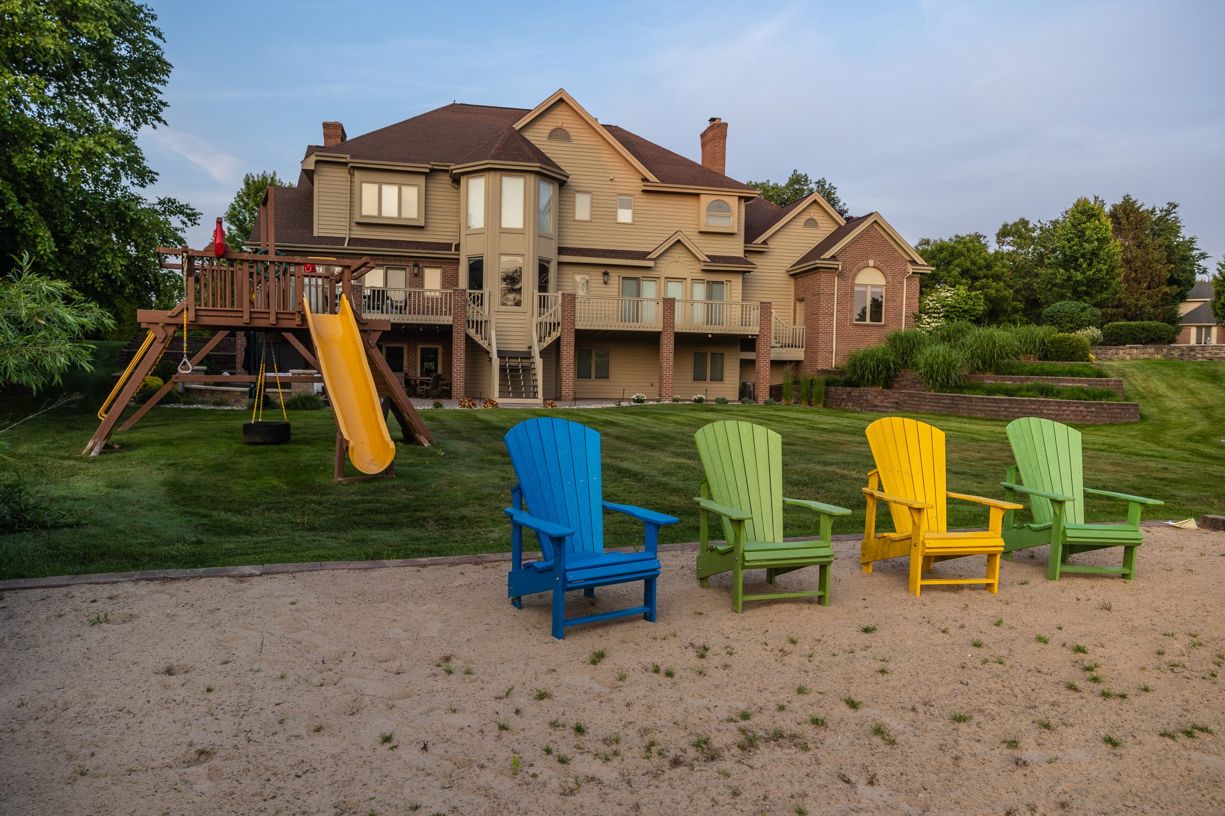 Colorful chairs and playset in backyard