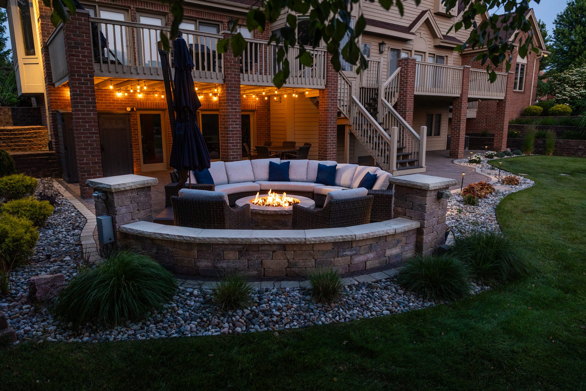 Backyard patio with fire pit and seating area.