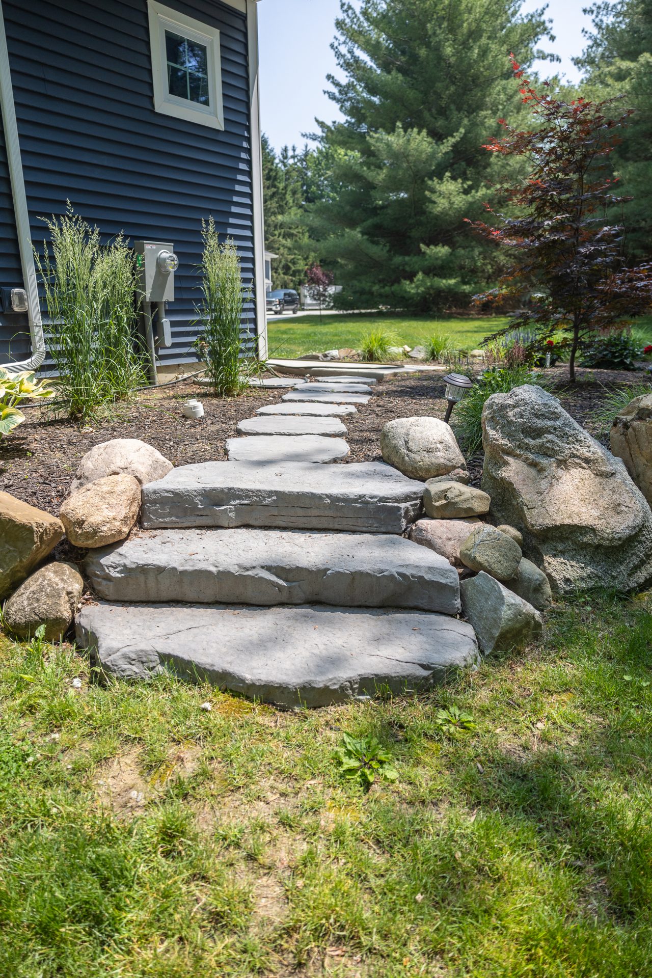 Stone path and steps by garden and house