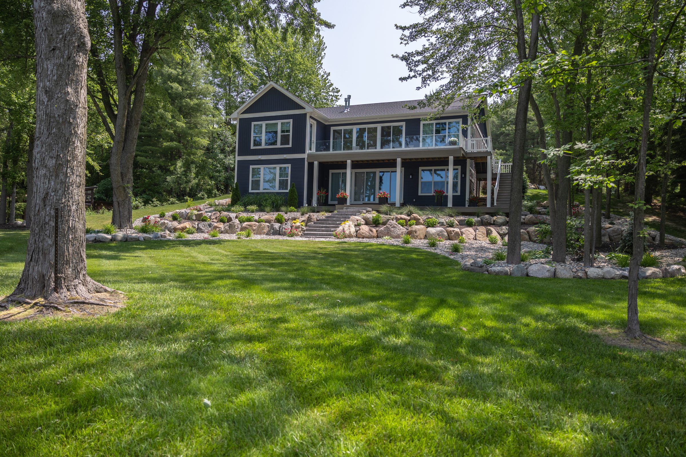 Two-story house with garden and trees