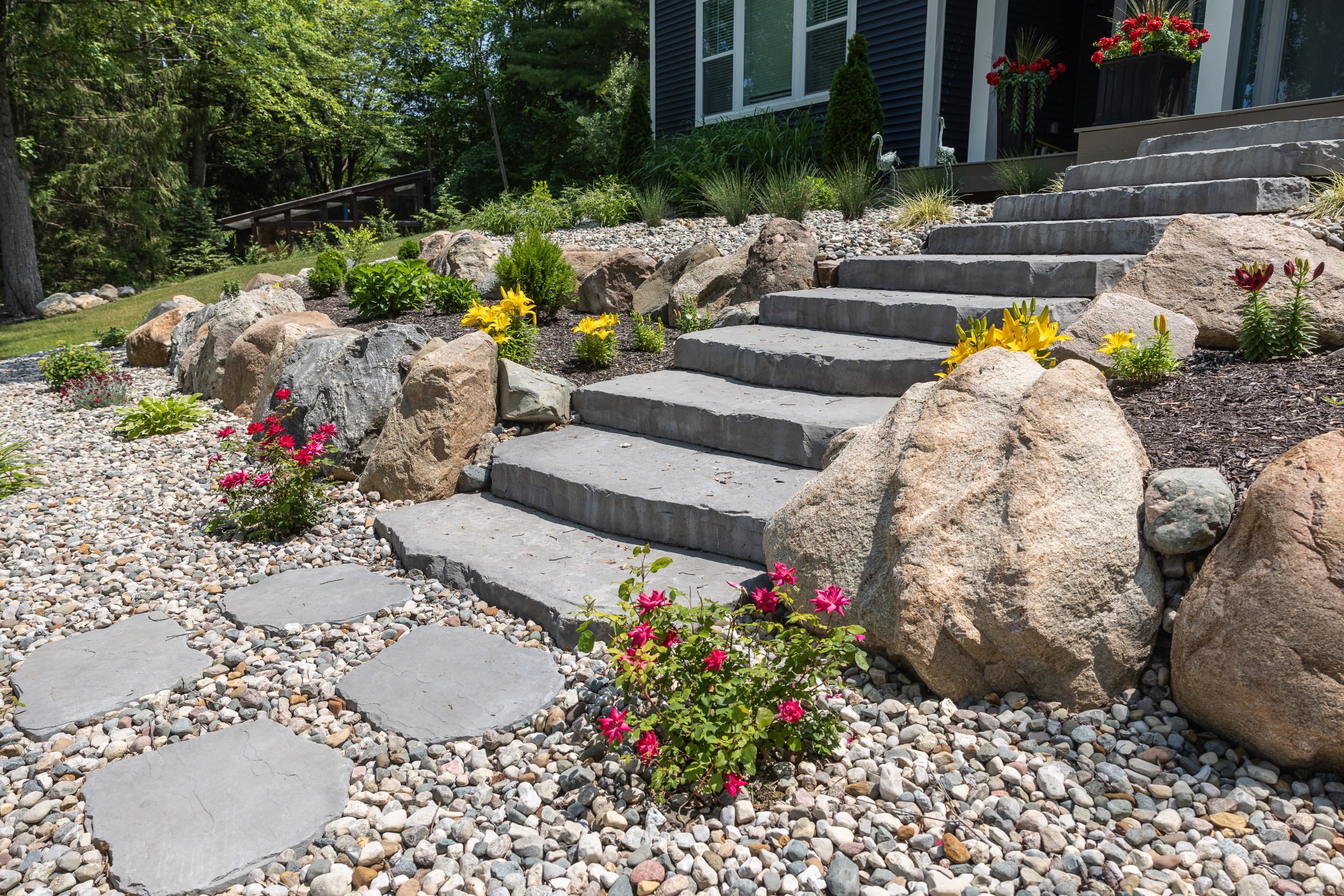 Stone steps with colorful garden landscaping.