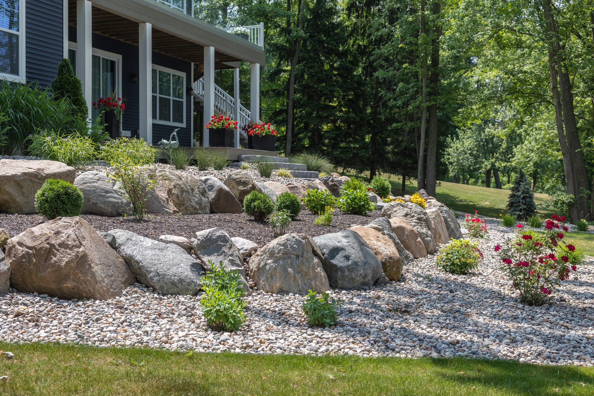 Beautiful landscaped garden with rocks and flowers.