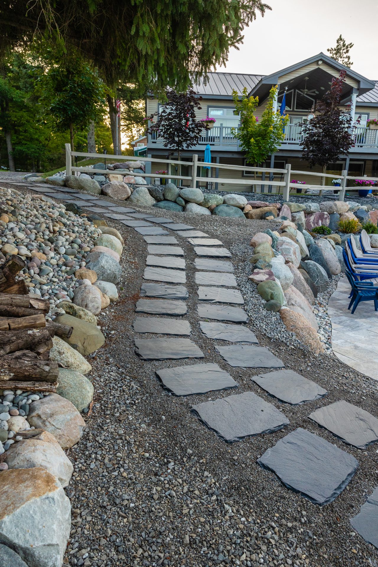 Stone path leading to a house with garden.