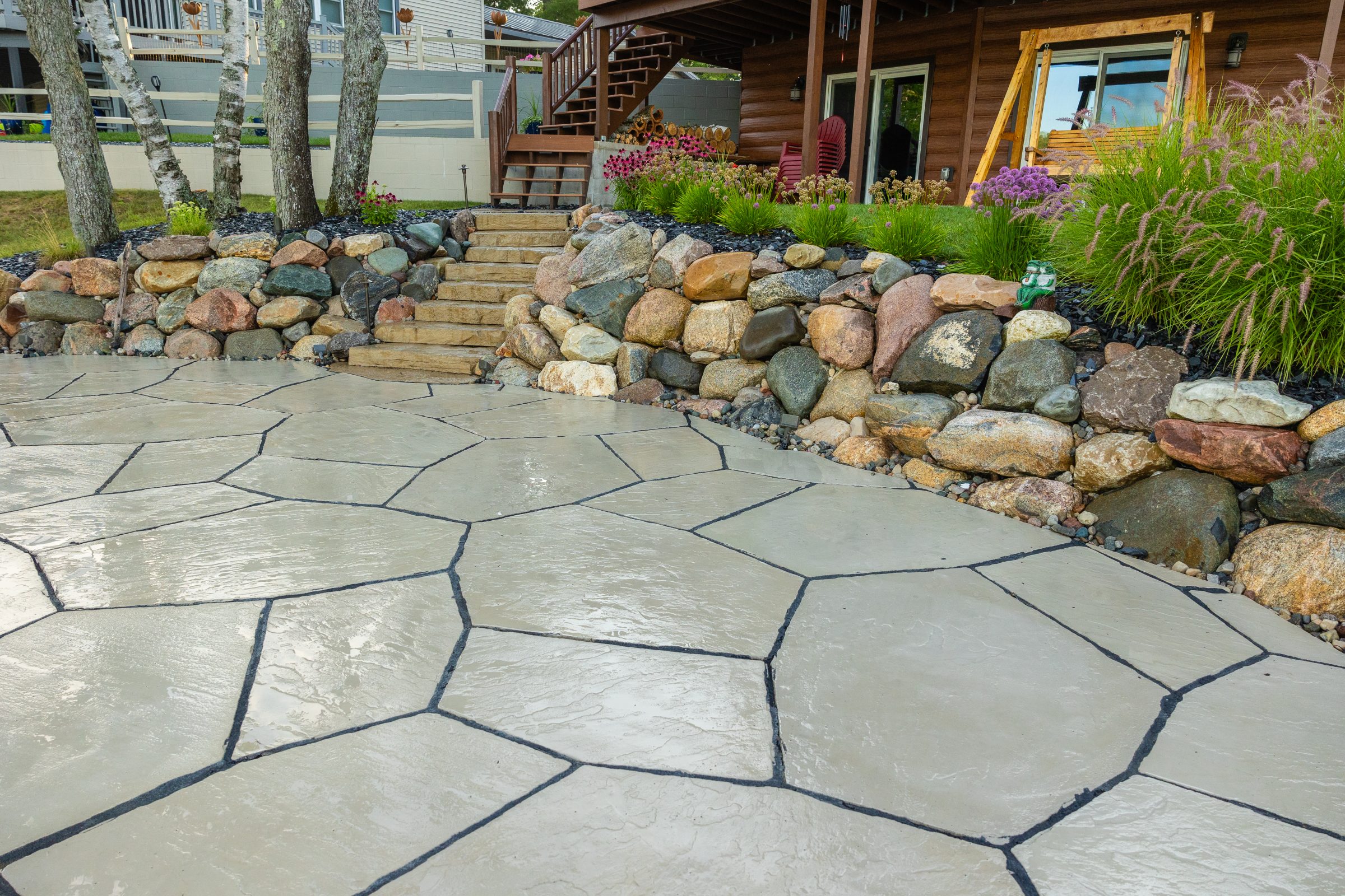 Stone patio with steps and garden border
