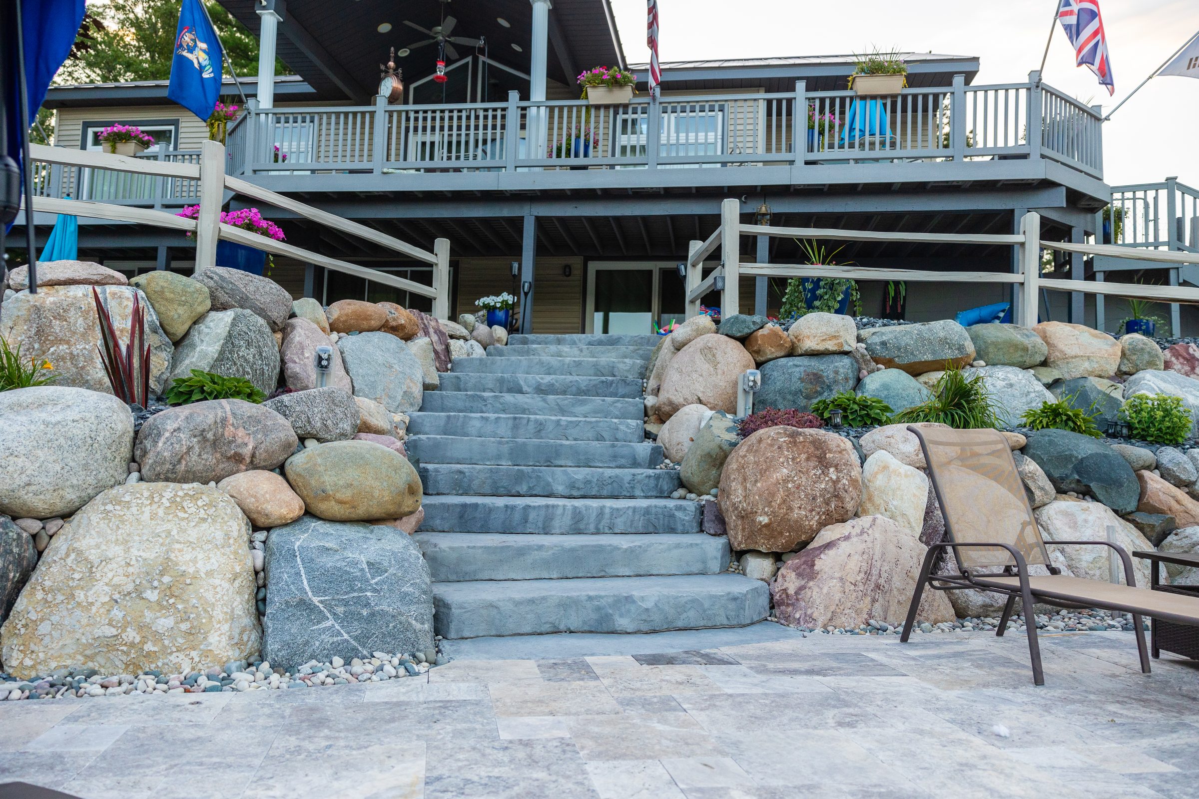 Stone staircase leading to house with balcony.