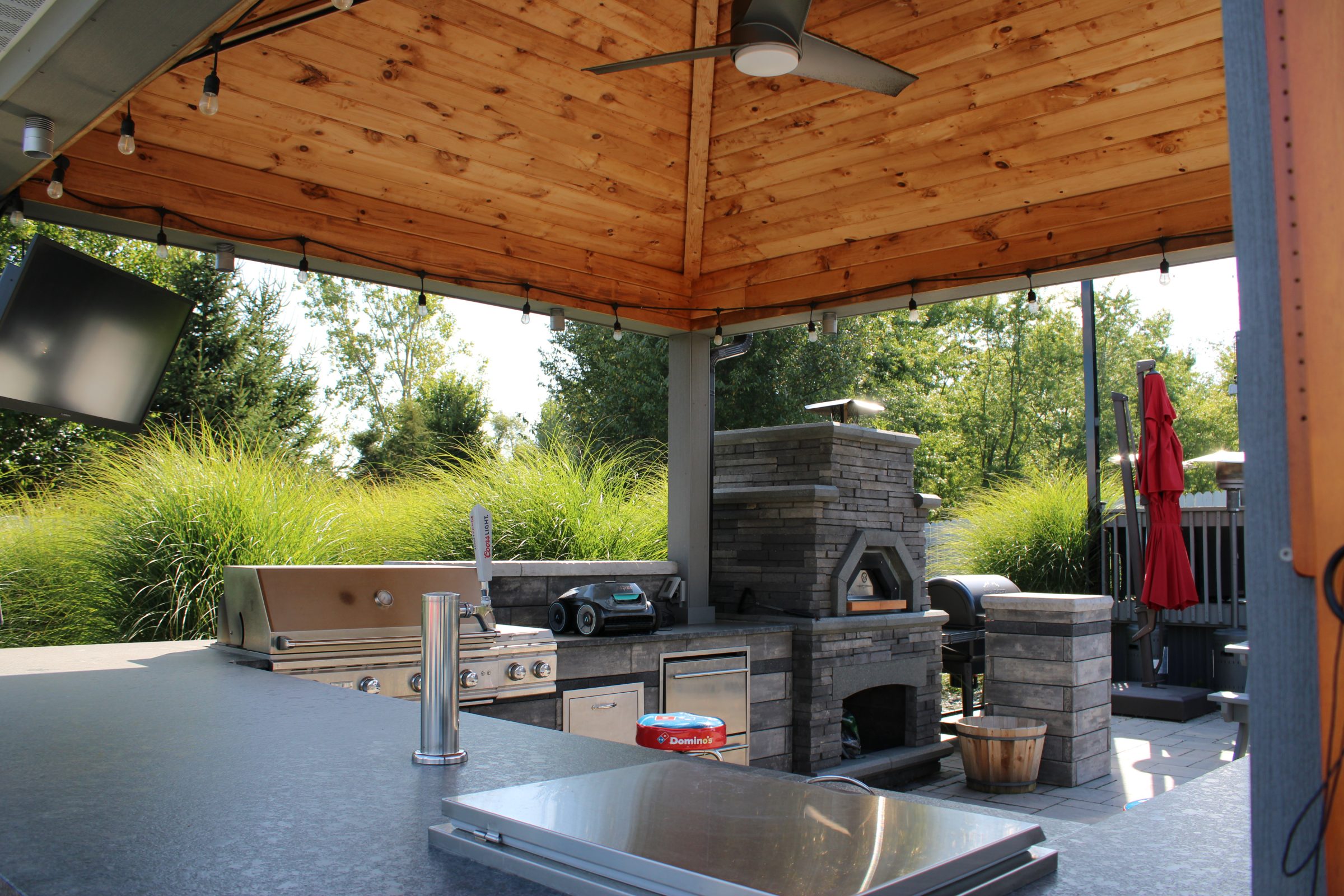 Outdoor kitchen with stone oven and grill.