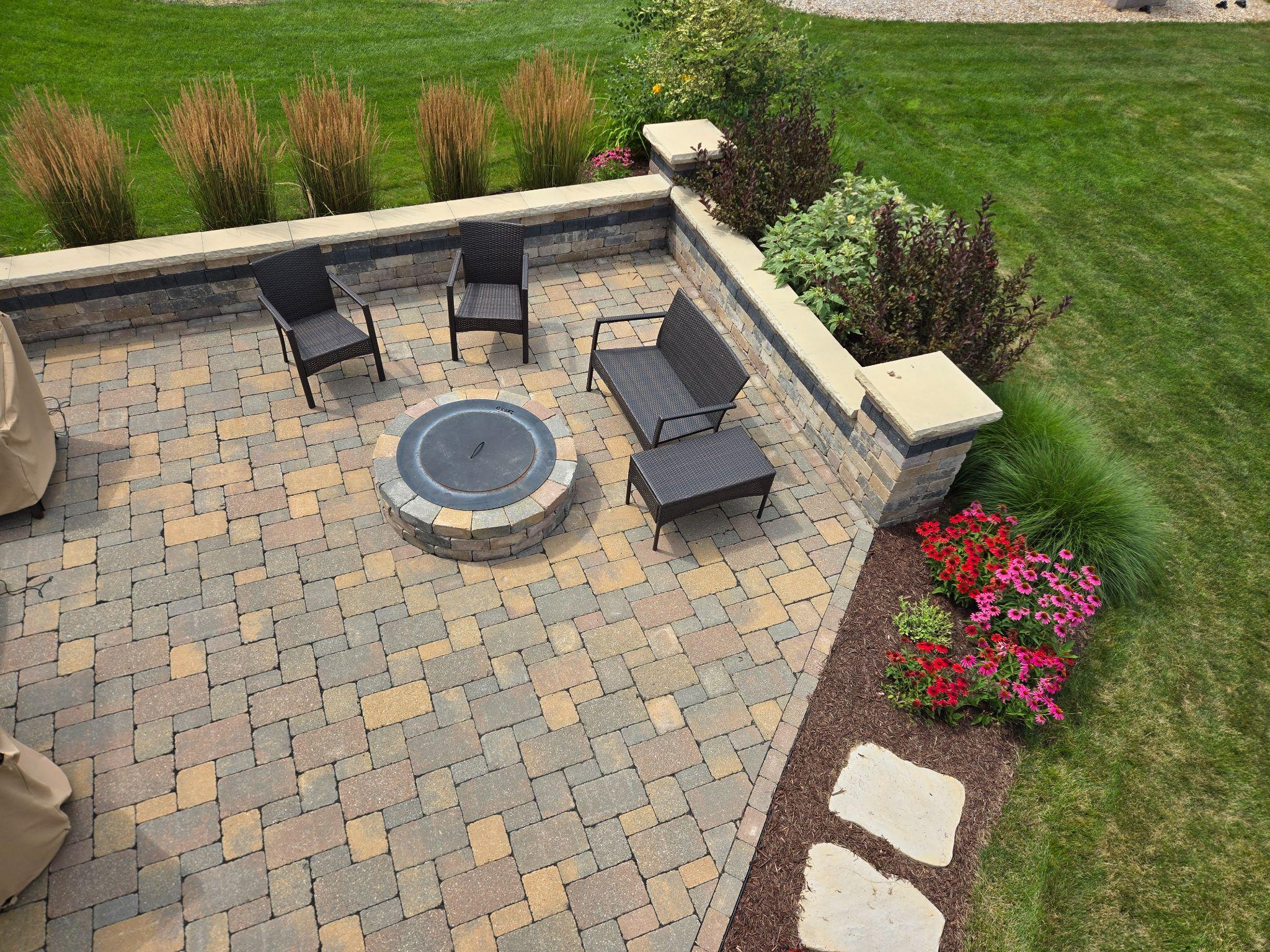 Paver patio with fire pit, seating wall, and landscaped borders